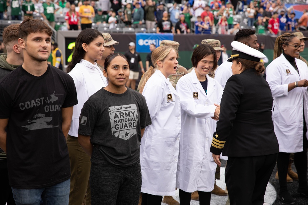 Service members from each branch welcome the New York Jets to the