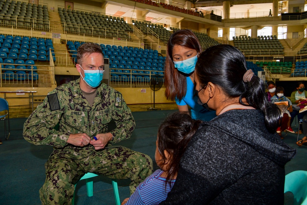 U.S. Navy and Air Force medical professionals conduct post operation check-ups