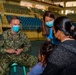 U.S. Navy and Air Force medical professionals conduct post operation check-ups