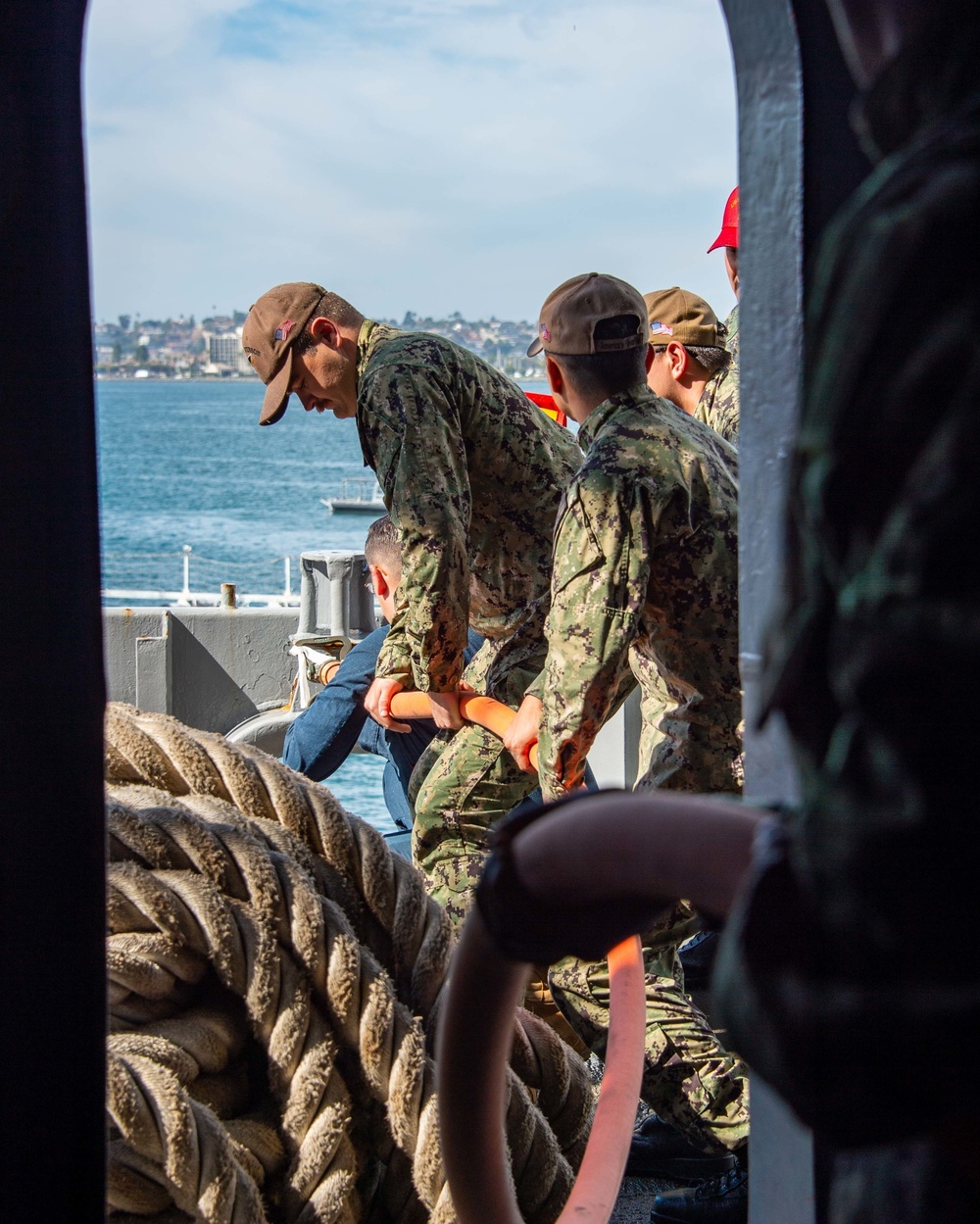 Sailors run damage control drills on the fantail of USS Carl Vinson