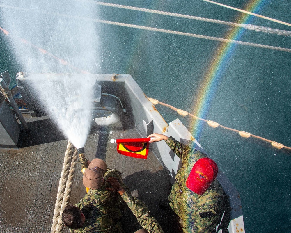 Sailors run damage control drills on the fantail of USS Carl Vinson