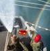 Sailors run damage control drills on the fantail of USS Carl Vinson