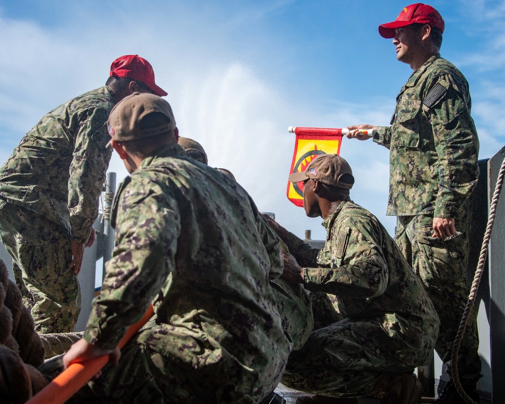 Sailors run damage control drills on the fantail of USS Carl Vinson