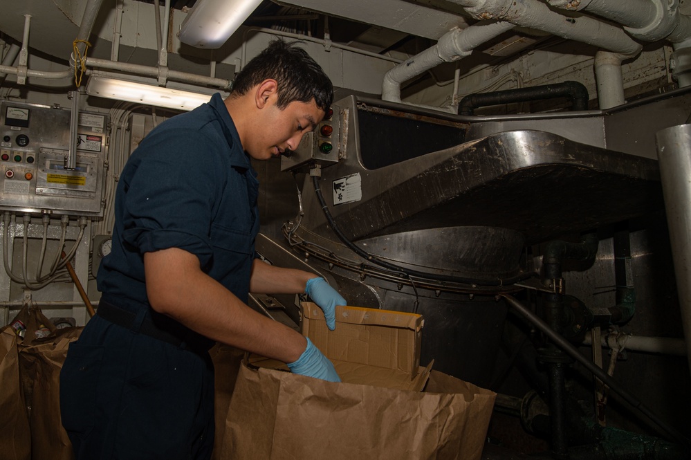 USS Ronald Reagan (CVN 76) Sailors perform waste management duties