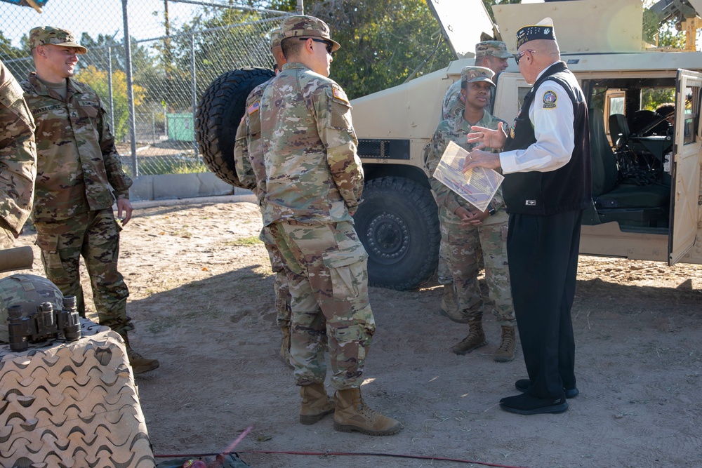 Soldiers from 1st Armored Division speak with a veteran during Fabens Park Veterans Day Ceremony