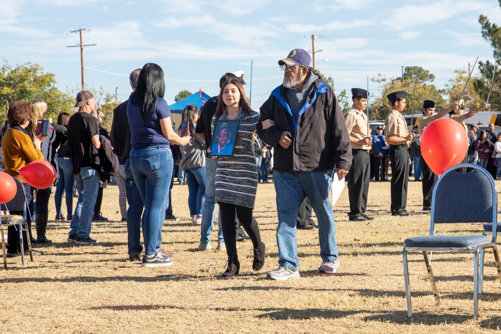 Local high school student escorts a veteran to his seat during Fabens Park Veterans Day Ceremony