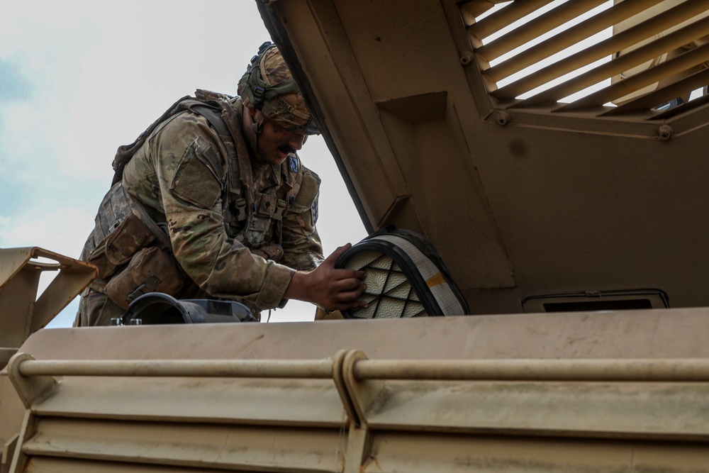 Engineer Soldiers form the 130th Engineer Brigade conduct preventive maintenance on their vehicles and weapon systems