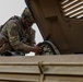 Engineer Soldiers form the 130th Engineer Brigade conduct preventive maintenance on their vehicles and weapon systems