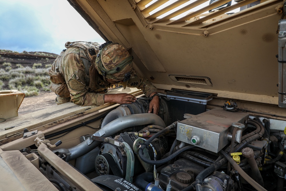 Engineer Soldiers form the 130th Engineer Brigade conduct preventive maintenance on their vehicles and weapon systems