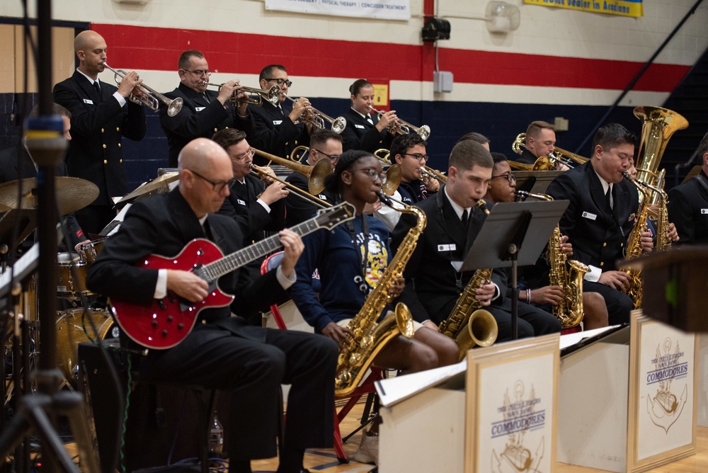 The U.S. Navy Band Commodores perform at Ovey Comeaux High School in Lafayette, Louisiana.