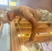 Builder 3rd Class Darren Levine, ensures that the wall studs are correctly spaced cement for the Richardson Multipurpose Facility on U.S. Army Garriso