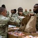 Soldiers, veterans, and volunteers distribute Thanksgiving care packages to families in need