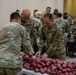 Soldiers, veterans, and volunteers distribute Thanksgiving care packages to families in need
