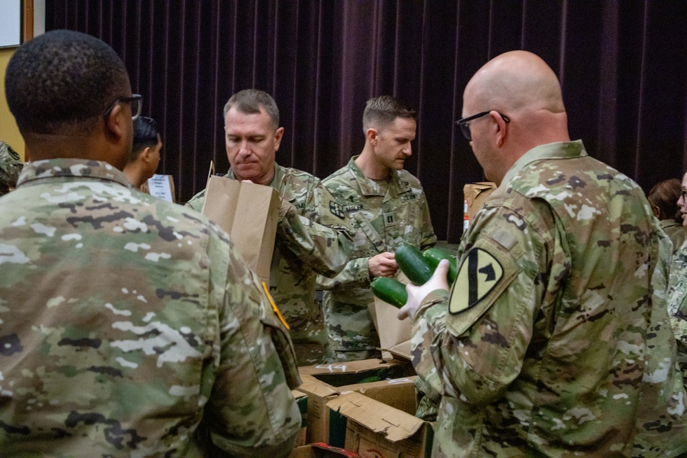 Soldiers, veterans, and volunteers distribute Thanksgiving care packages to families in need