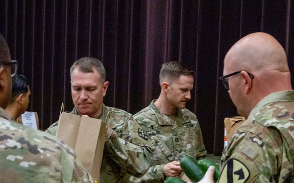 Soldiers, veterans, and volunteers distribute Thanksgiving care packages to families in need