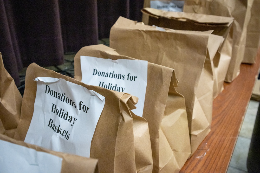 Soldiers, veterans, and volunteers distribute Thanksgiving care packages to families in need