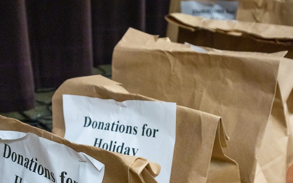 Soldiers, veterans, and volunteers distribute Thanksgiving care packages to families in need