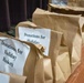 Soldiers, veterans, and volunteers distribute Thanksgiving care packages to families in need