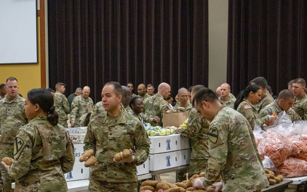 Soldiers, veterans, and volunteers distribute Thanksgiving care packages to families in need