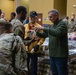 Soldiers, veterans, and volunteers distribute Thanksgiving care packages to families in need