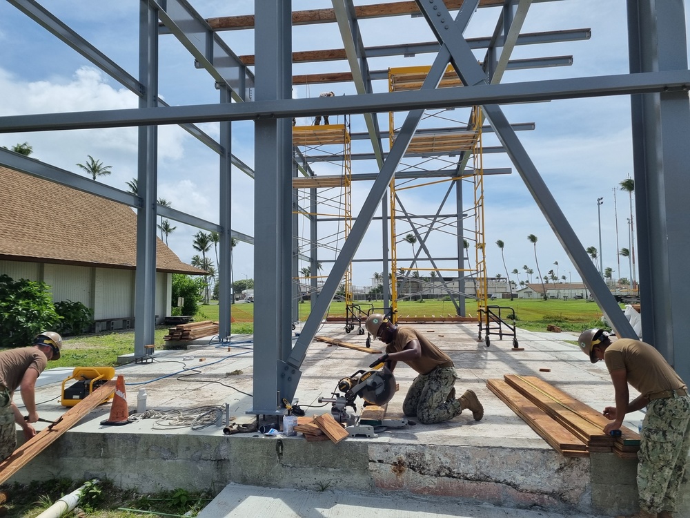 Seabees with Naval Mobile Construction Battalion 4, prefabricates walls for an outdoor multipurpose facility onboard U.S. Army Garrison - Kwajalein Atoll.