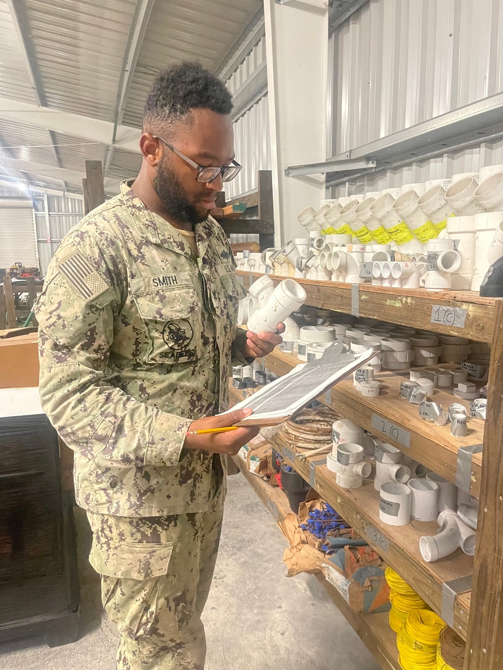 Equipment Operator 3rd Class Bobby Smith, conducts inventory of project materials for the Richardson Multipurpose Facility.