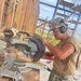 Steelworker 3rd Class Daniel Ceren, cuts support beams needed for the Richardson Multipurpose Facility.