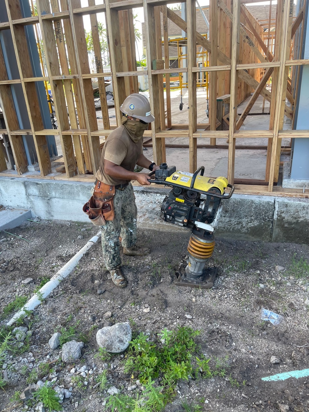 Builder 3rd Class Carlos Hernandez, operates a mechanical compactor on site at The Richardson Multipurpose Facility Project.