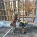 Builder 3rd Class Carlos Hernandez, operates a mechanical compactor on site at The Richardson Multipurpose Facility Project.