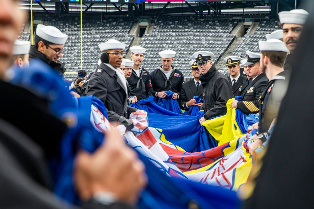 USS Arlington Sailors and Marines participate in pregame ceremonies