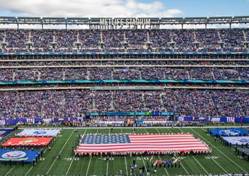 USS Arlington Sailors and Marines participate in pregame ceremonies
