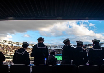 USS Arlington Sailors and Marines participate in pregame ceremonies