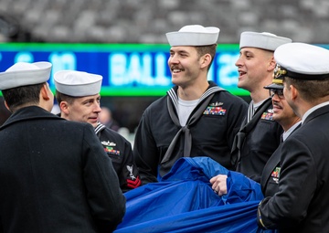 USS Arlington Sailors and Marines participate in pregame ceremonies