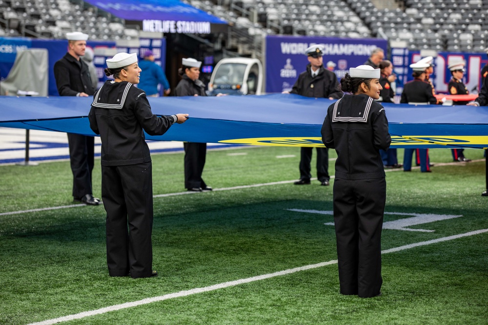 USS Arlington Sailors and Marines participate in pregame ceremonies