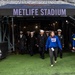 USS Arlington Sailors and Marines participate in pregame ceremonies