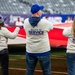 USS Arlington Sailors and Marines participate in pregame ceremonies