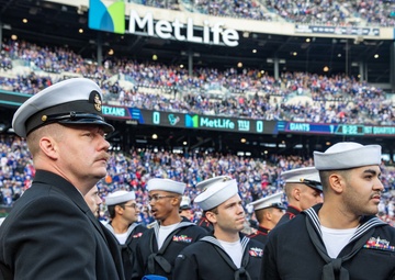 USS Arlington Sailors and Marines participate in pregame ceremonies