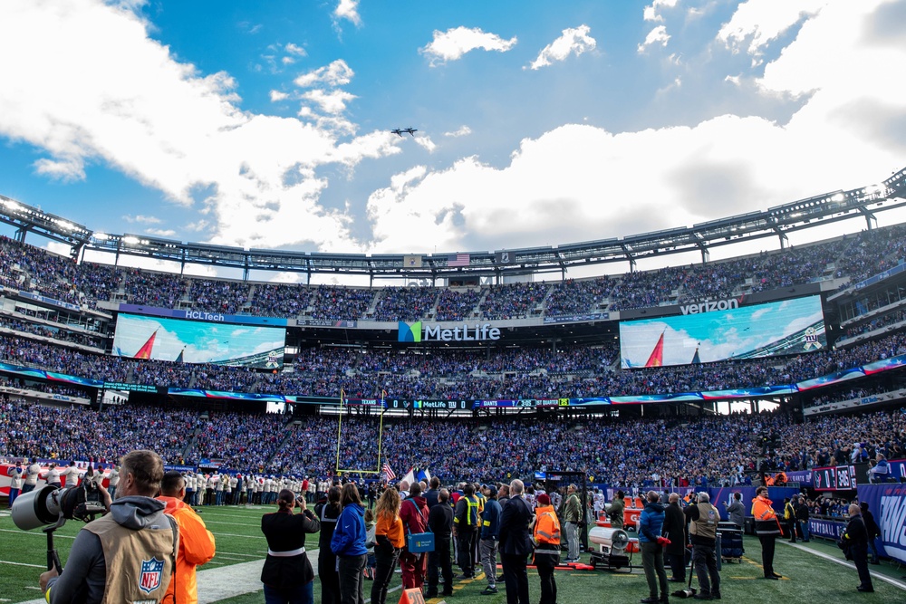 USS Arlington Sailors and Marines participate in pregame ceremonies