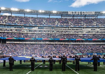USS Arlington Sailors and Marines participate in pregame ceremonies