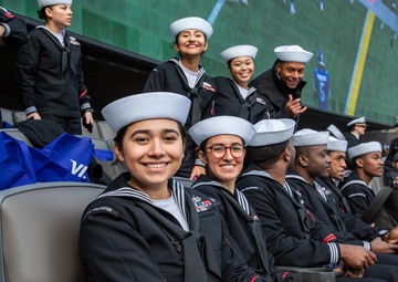 USS Arlington Sailors and Marines participate in pregame ceremonies