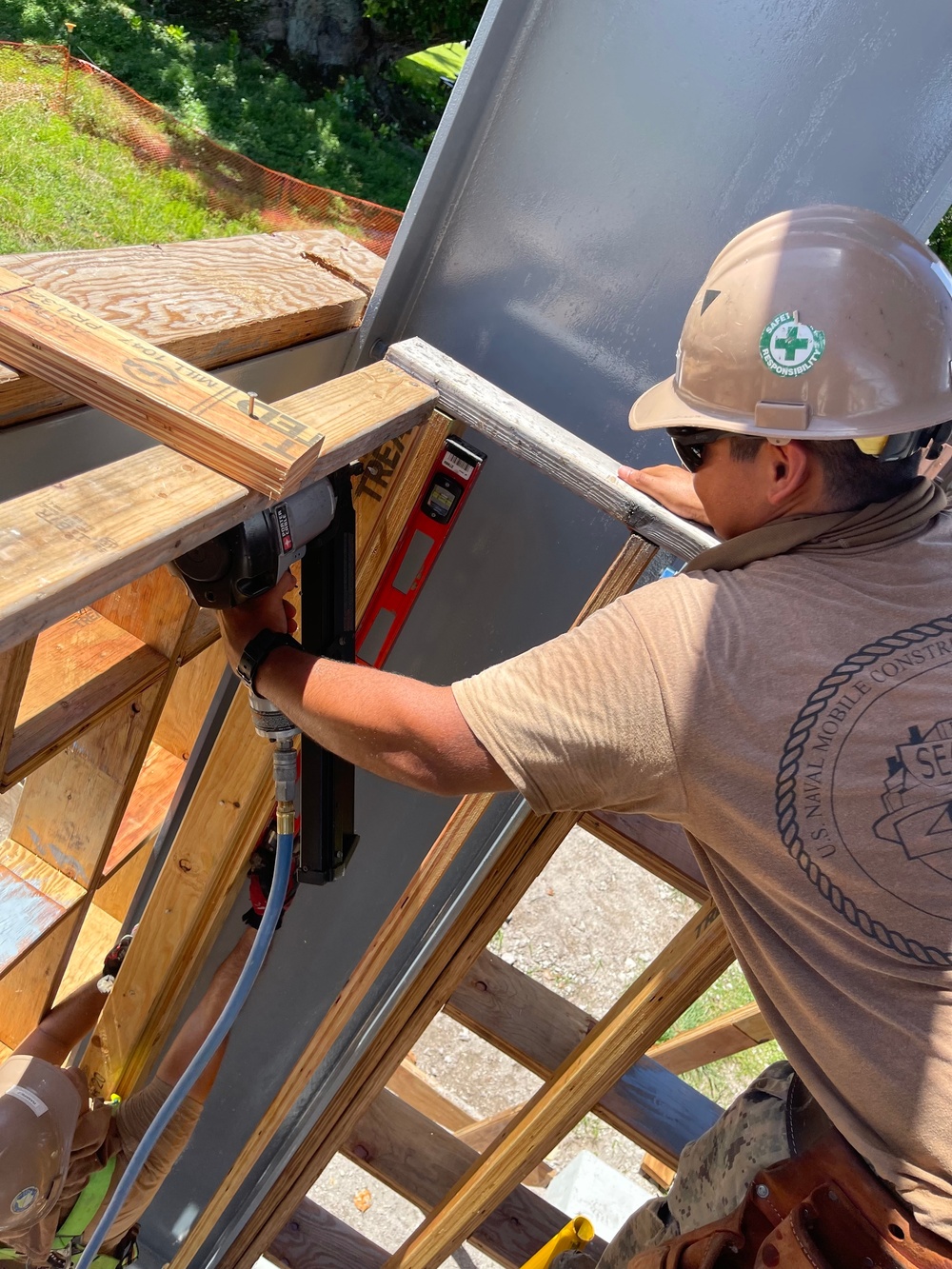 Seabees with Naval Mobile Construction Battalion 4, secure support beams for a wall as part of the Richardson Multipurpose Facility Project on U.S. Army Garrison - Kwajalein Atoll.