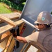 Seabees with Naval Mobile Construction Battalion 4, secure support beams for a wall as part of the Richardson Multipurpose Facility Project on U.S. Army Garrison - Kwajalein Atoll.