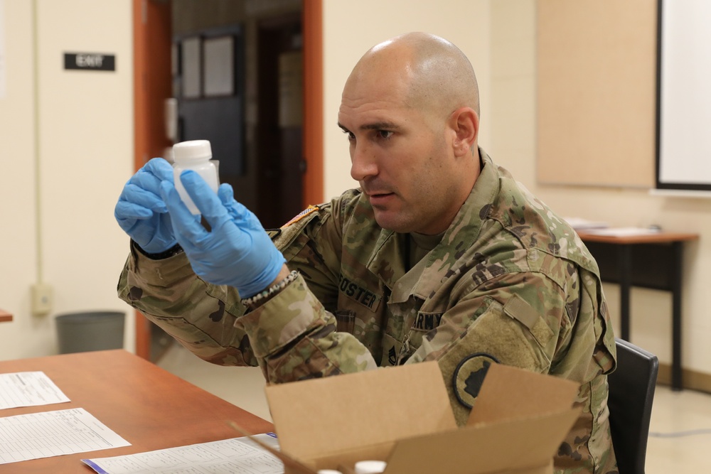 Soldier examining prescription bottle