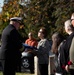 U.S. Navy Captain Pete Moore presents the National Ensign to the family of Radioman 3rd Class Charles Montgomery