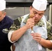 CS3 Kim Tuerto from USS Pearl Harbor (LSD 52) creates a cake design on a flower nail during cake decorating seminar.