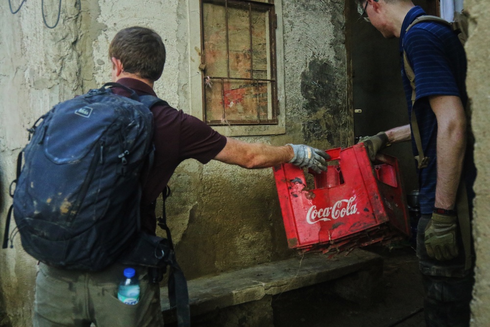 City Officials, Security Force Personnel Clean Up Flooded Zamboanga