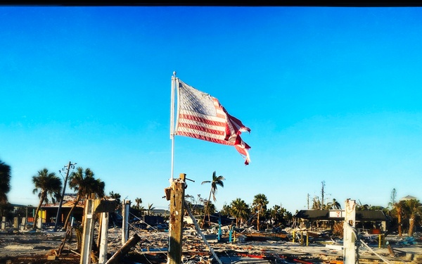 A Flag Blows in the Wind Amid Damage From Hurricane Ian