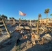 A Flag Blows in the Wind Among Damage on Fort Myers Beach