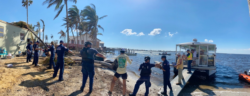 People Help Load Supplies on a Ferry to Pine Island