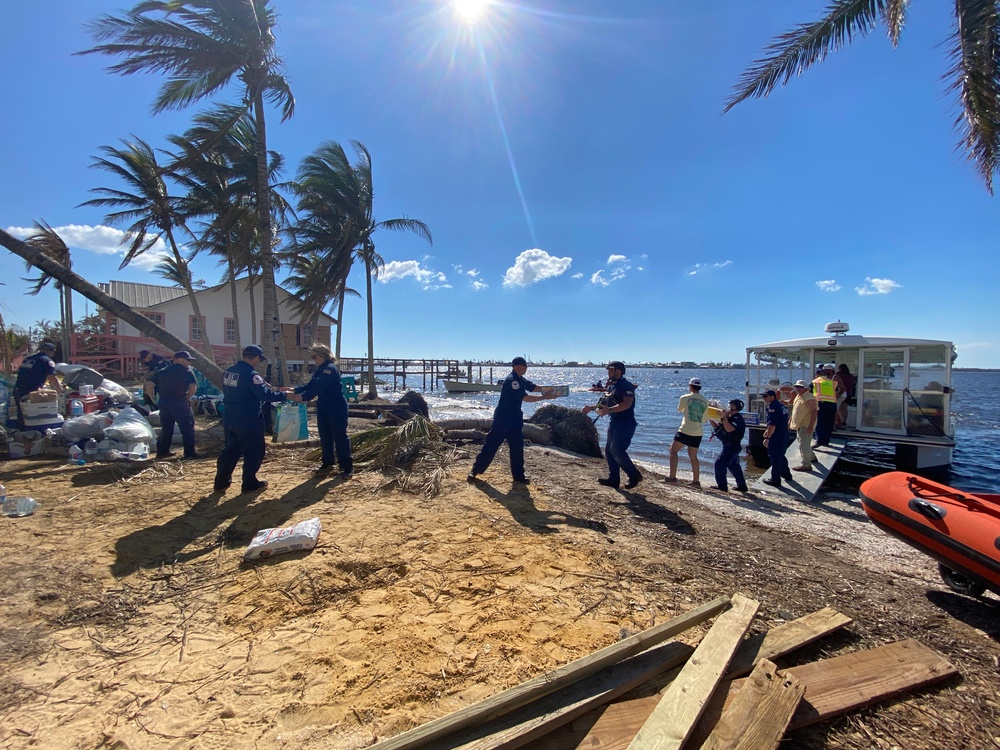 People Help Load Supplies on a Ferry to Pine Island